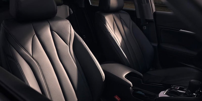 Front interior view of an Acura sedan featuring black leather front seats