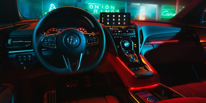 Interior of an Acura SUV featuring the steering wheel, instrument cluster