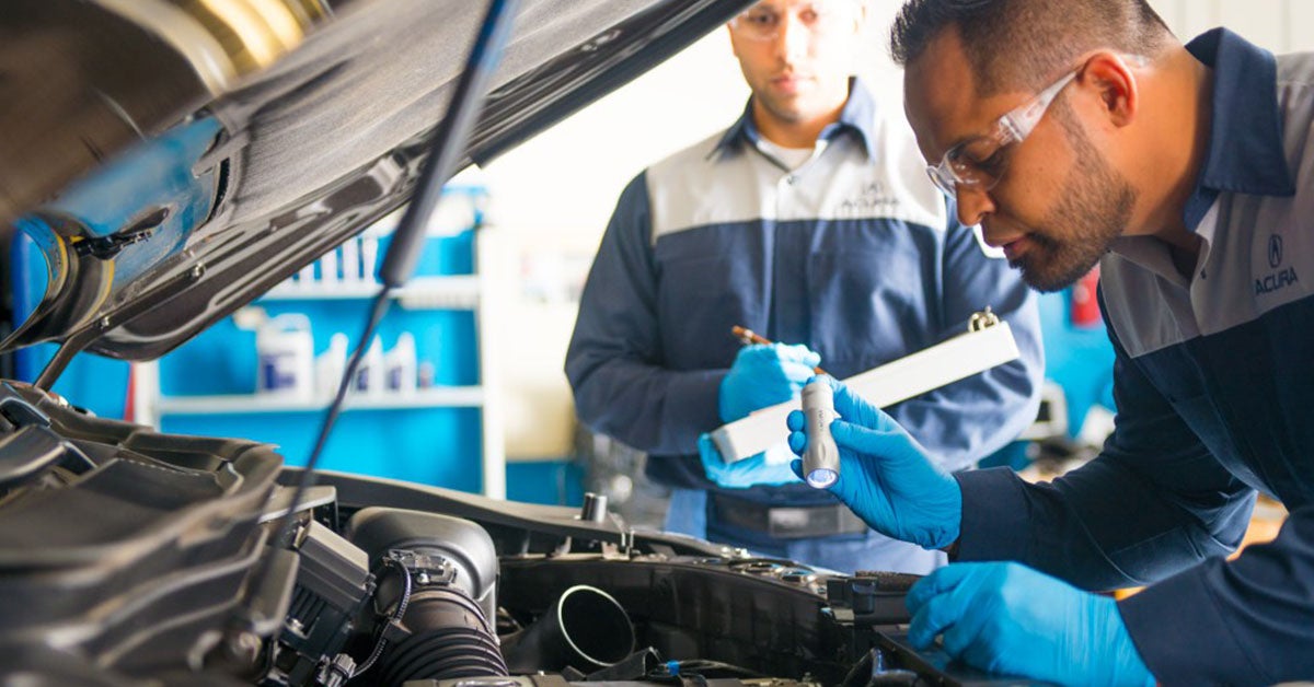 Acura service technician working under the hood